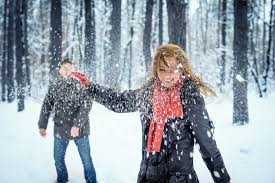 Winter couple having fun playing snow