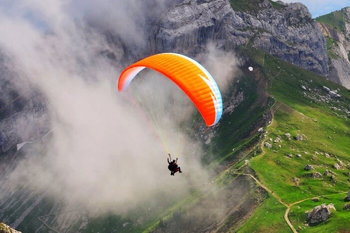 paragliding, cloud covered mountain, trees